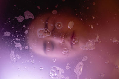 High angle view of woman with eyes closed in bathtub