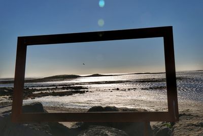 Scenic view of sea against clear sky during sunset