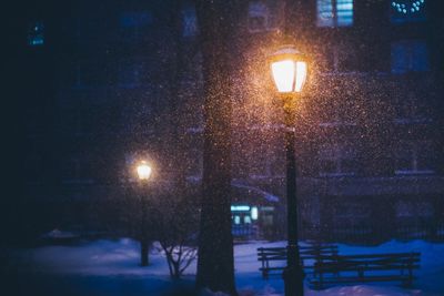 Illuminated gas light during snowfall at night