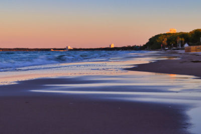 Scenic view of sea against clear sky during sunset