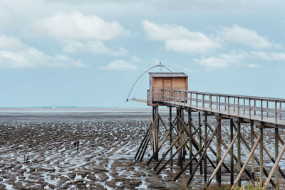 Lifeguard hut on beach against sky