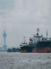 Ship at harbor against sky