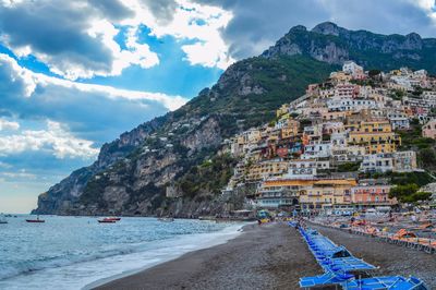 Scenic view of sea and mountains against sky