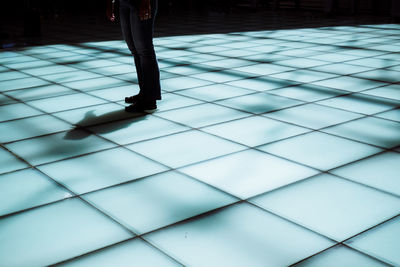 Low section of man on tiled floor