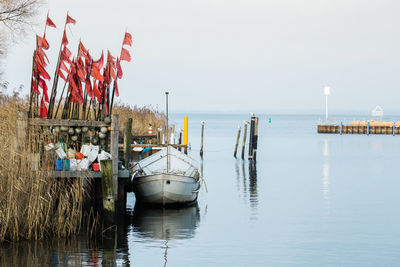 Boats in sea against clear sky