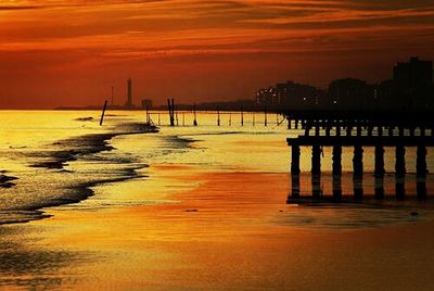 Pier on sea at sunset