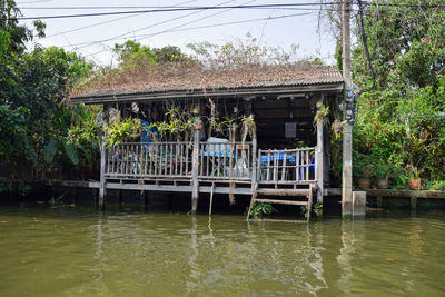 Bridge over river by house and trees