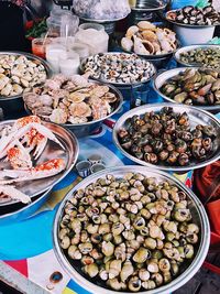 High angle view of various seafood in containers for sale at street market