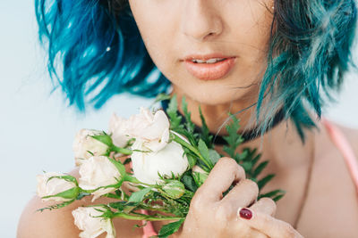 Close-up of woman holding rose bouquet