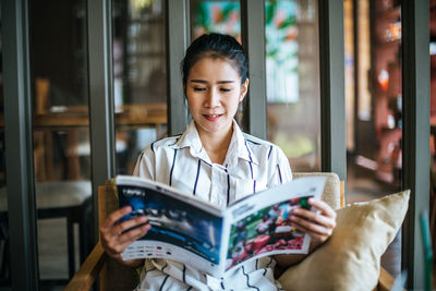 Young woman reading book