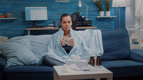 Woman sitting on sofa at table