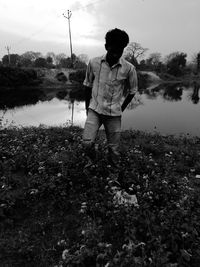 Man standing on field against sky