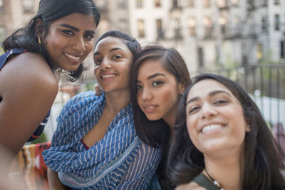 Young women posing for a photograph at a party together