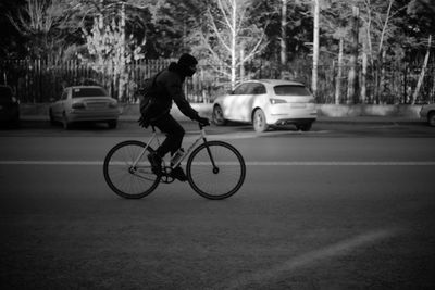 Man riding bicycle on road