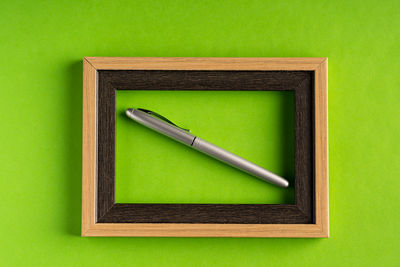 High angle view of pen on green box