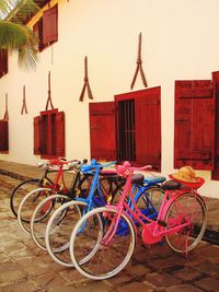 Bicycles parked against wall in city