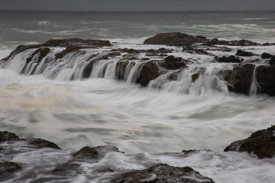 Scenic view of sea against rocks