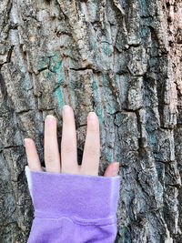 Close-up of woman hand on wall