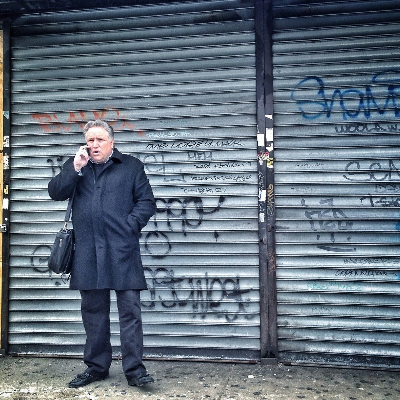 casual clothing, standing, lifestyles, full length, young adult, front view, person, wall - building feature, leisure activity, built structure, looking at camera, brick wall, architecture, portrait, three quarter length, building exterior, jacket, hands in pockets