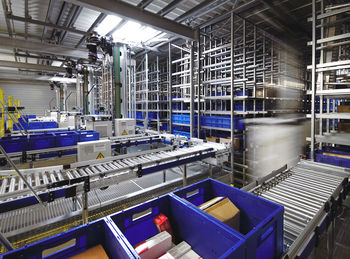 Automated warehouse. boxes with spare parts moving on conveyer