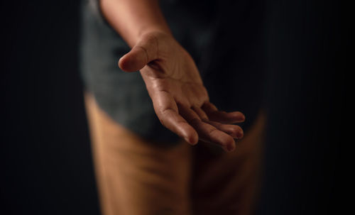 Midsection of man showing hand