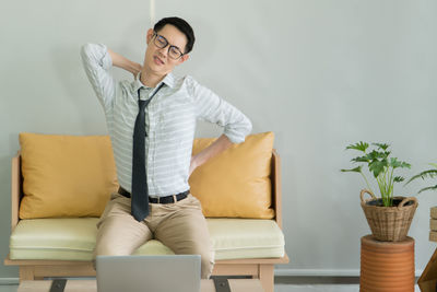 Young man sitting on sofa