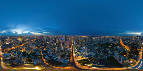 High angle view of city lit up at night