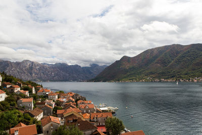 Perast, roofs of old houses in perast and bay with mountains in montenegro