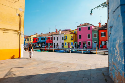 People on street against buildings in city