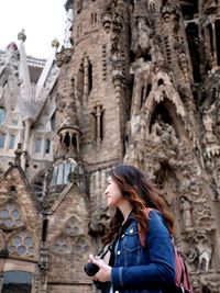 Side view of a woman outside a building