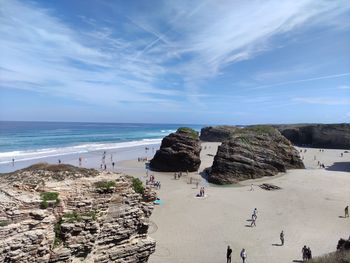 Scenic view of rocks on beach against sky