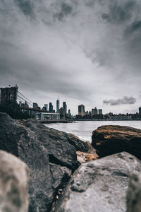 Scenic view of sea by buildings against sky