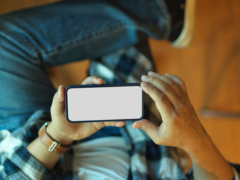 Midsection of man using mobile phone