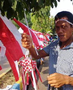 Portrait of man holding red flag