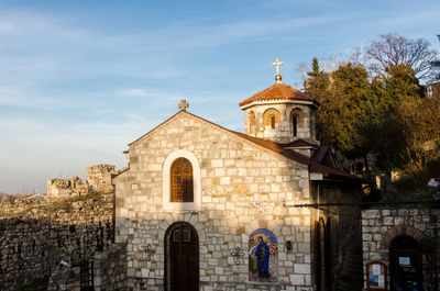 Facade of bell tower against sky