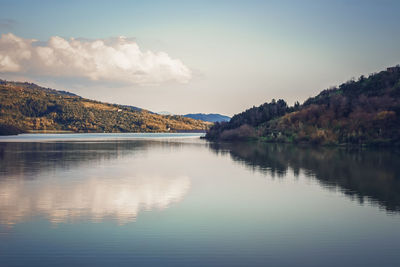 Autumn forest reflected in the water. colorful autumn morning in the mountains. colorful autumn