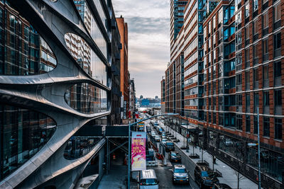 View of city street and buildings against sky