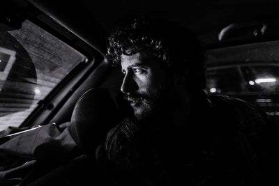 Portrait of man sitting in car