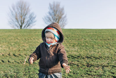 Girl standing on land against sky