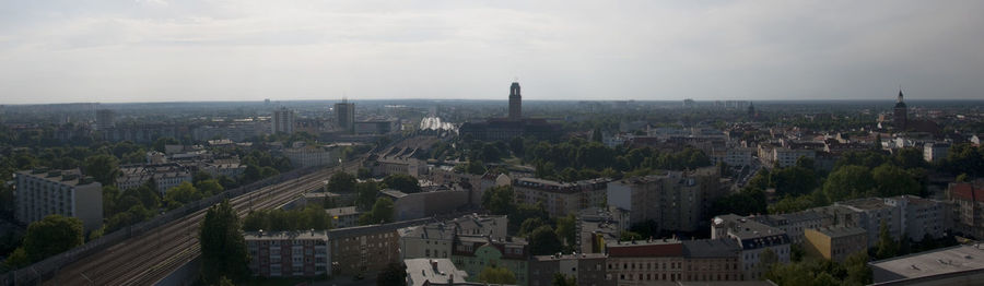 Cityscape against cloudy sky