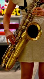 Midsection of woman playing saxophone