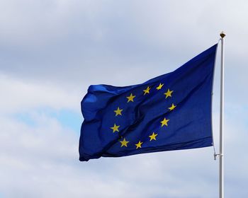 Low angle view of european union flag against blue sky