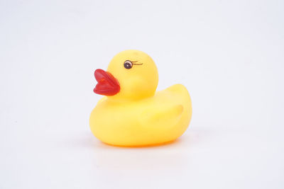 Close-up of yellow toy over white background