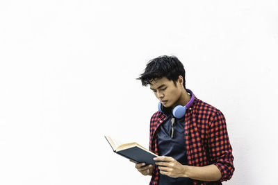 Full length of man standing against white background