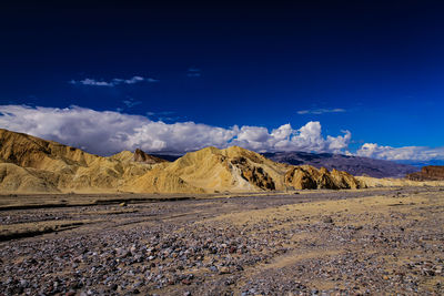 Scenic view of desert against blue sky