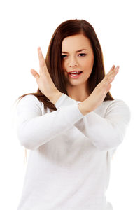 Portrait of smiling young woman against white background