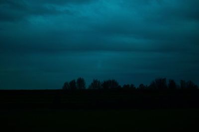 Scenic view of silhouette landscape against sky at night