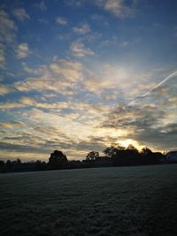 Scenic view of field against sky at sunset