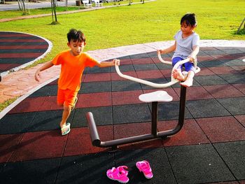 High angle view of siblings playing on ground