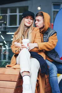 Young couple sitting outdoors